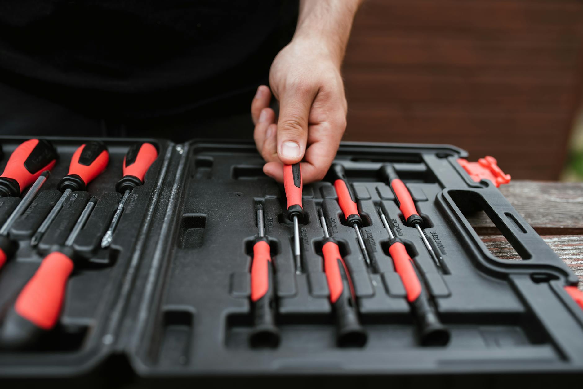 faceless master choosing screwdriver from toolbox